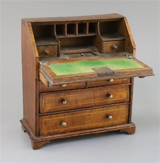 A mid 18th century style miniature walnut bureau, 9in., height 9.5in.